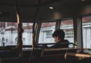 man inside bus using earphones